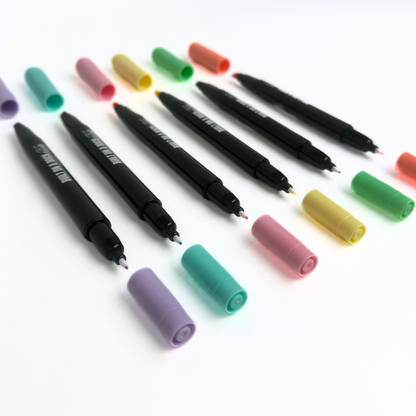 Pens laying straight with caps open
