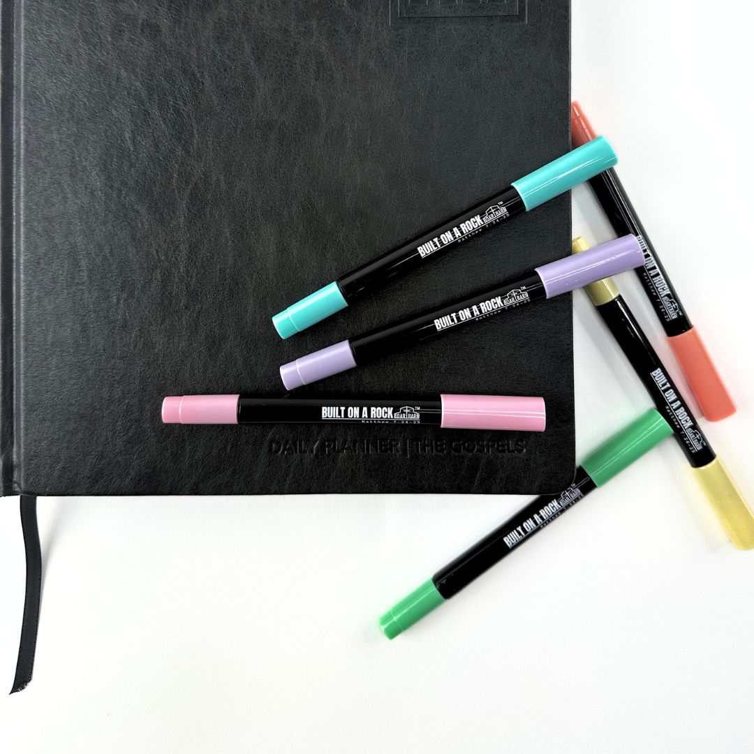 Pens scattered on planner