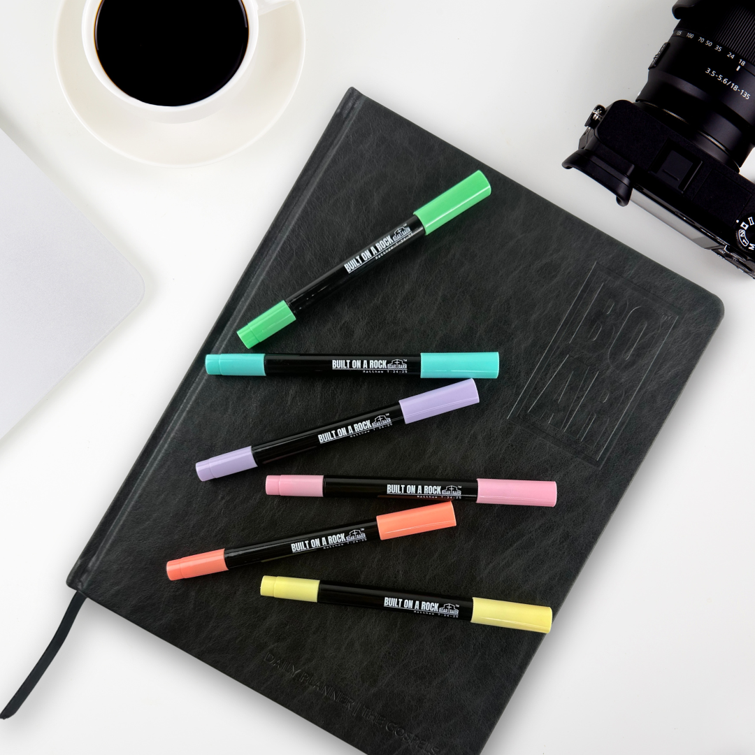 Pens on planner on desk
